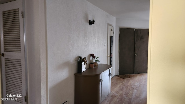 11325 Tom Ulozas Dr, El Paso, TX 79936 - hallway featuring wood finished floors and a heating unit