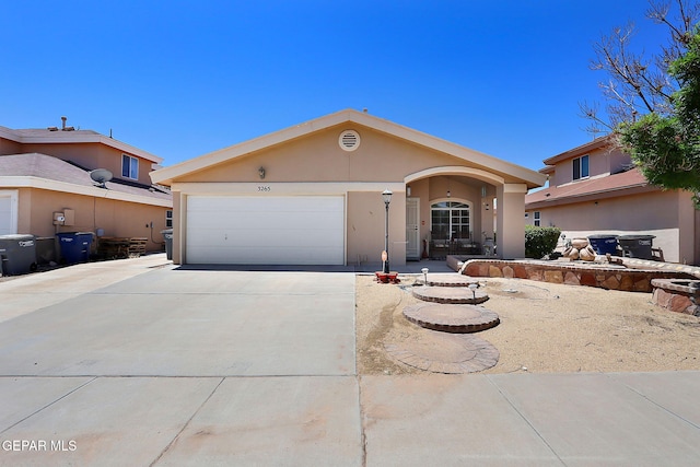 single story home with an attached garage, driveway, and stucco siding