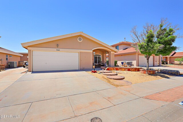 view of front of house featuring an attached garage, driveway, and stucco siding