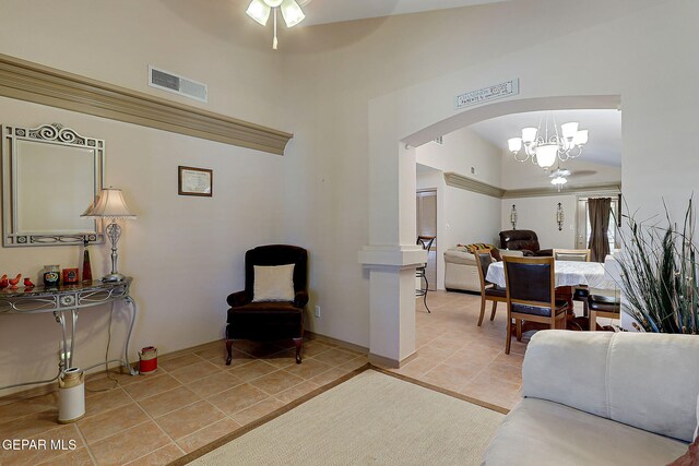 living room with visible vents, baseboards, arched walkways, ceiling fan with notable chandelier, and light tile patterned floors