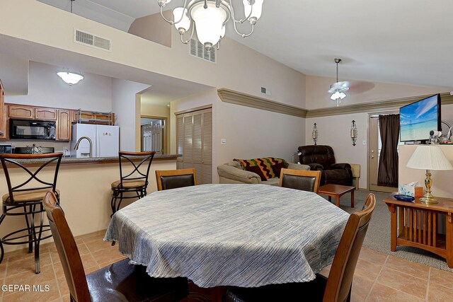 dining room with high vaulted ceiling and visible vents