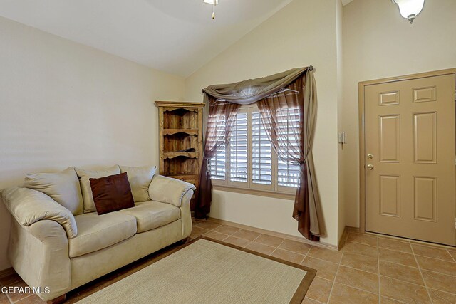 living room featuring light tile patterned floors and vaulted ceiling