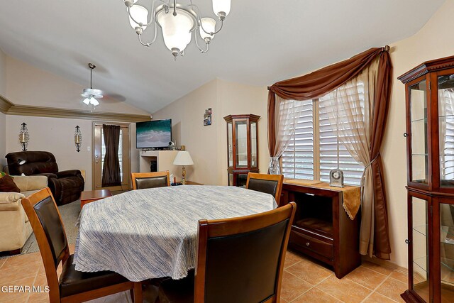 dining room with light tile patterned flooring, lofted ceiling, and ceiling fan with notable chandelier