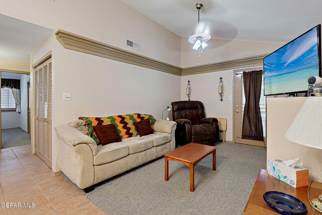 living area with ceiling fan, light colored carpet, light tile patterned flooring, and visible vents