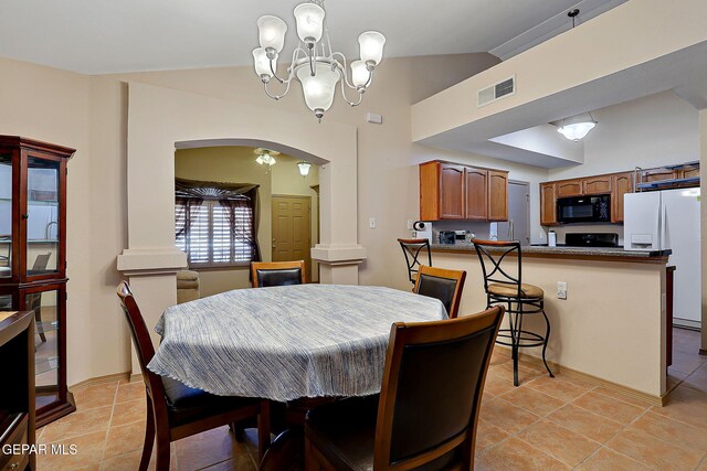 dining space with light tile patterned floors, arched walkways, a chandelier, and visible vents