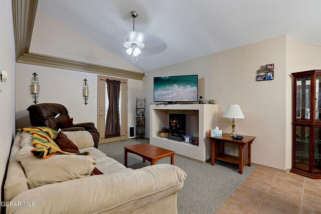 living area with vaulted ceiling, baseboards, and a ceiling fan