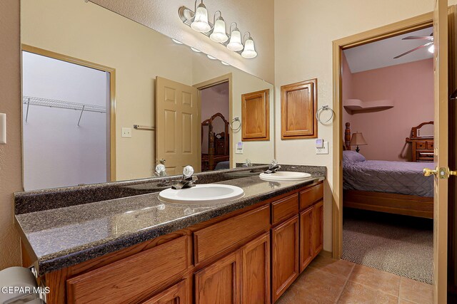 ensuite bathroom featuring ensuite bathroom, a sink, tile patterned flooring, and double vanity