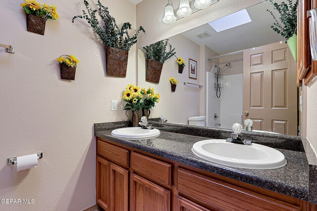 full bath featuring toilet, visible vents, a sink, and a shower