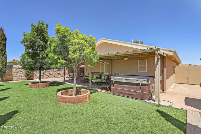 view of front facade with a patio, a front lawn, and a hot tub