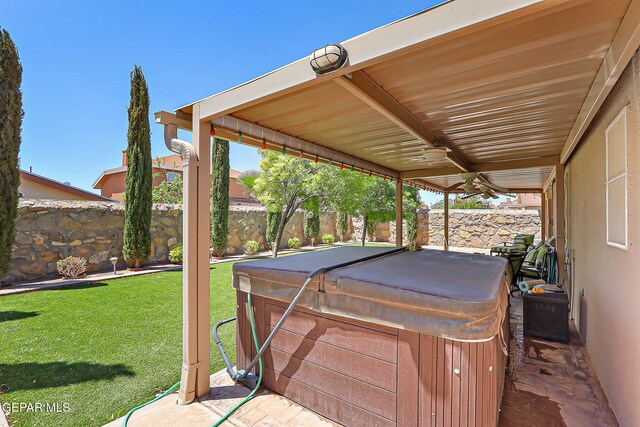 view of patio featuring a fenced backyard, ceiling fan, and a hot tub