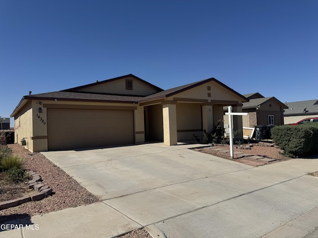 ranch-style house with a garage, stucco siding, and concrete driveway