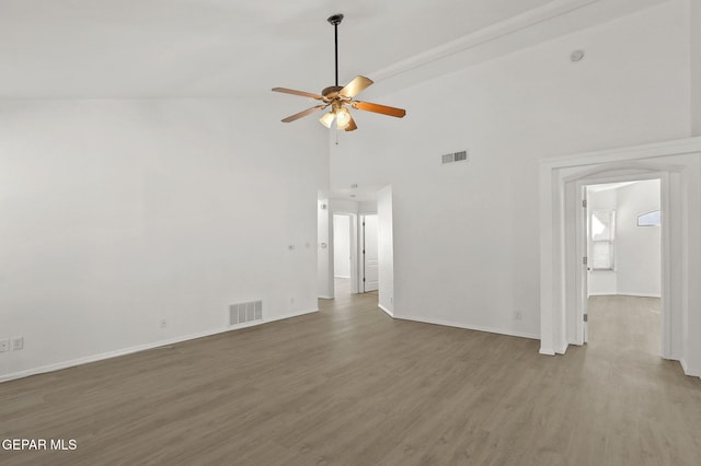 unfurnished living room with visible vents, a ceiling fan, wood finished floors, and high vaulted ceiling