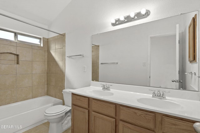 full bathroom featuring double vanity, toilet, tile patterned floors, and a sink
