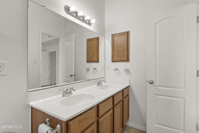 bathroom with a sink and double vanity