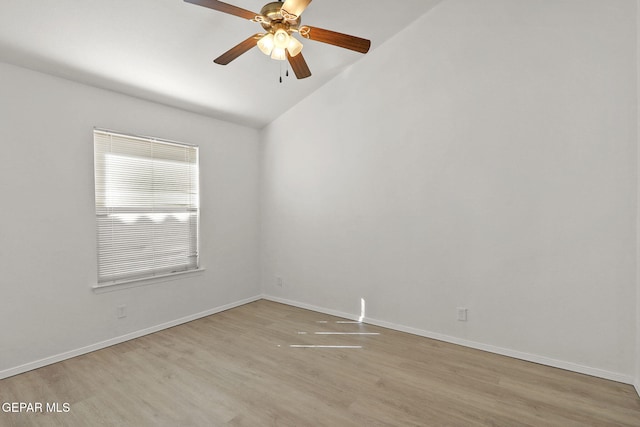 unfurnished room with wood finished floors, baseboards, ceiling fan, and lofted ceiling