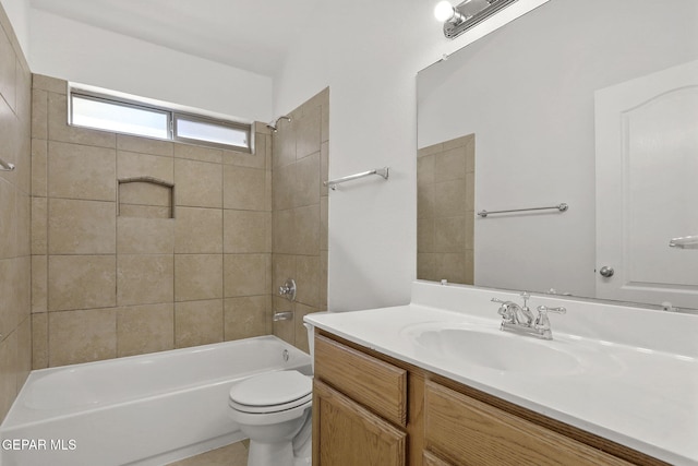 bathroom featuring vanity, toilet, and shower / washtub combination