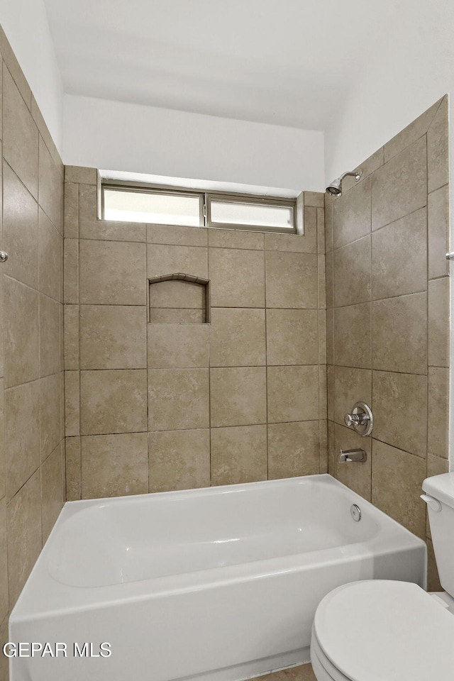 bathroom with toilet and  shower combination