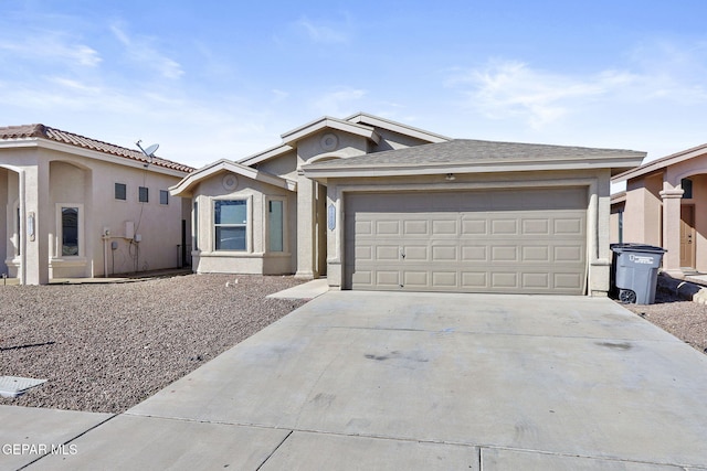 ranch-style house with a garage, stucco siding, and driveway