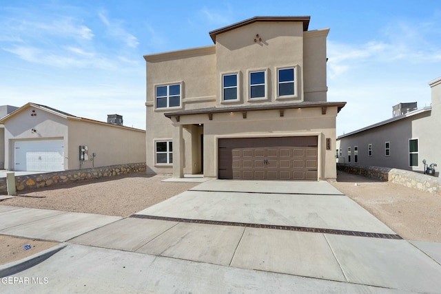view of front of home with an attached garage, stucco siding, and driveway