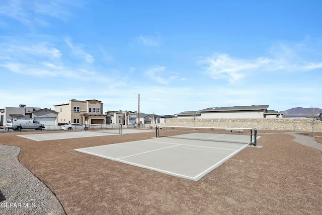 surrounding community featuring a residential view and a tennis court