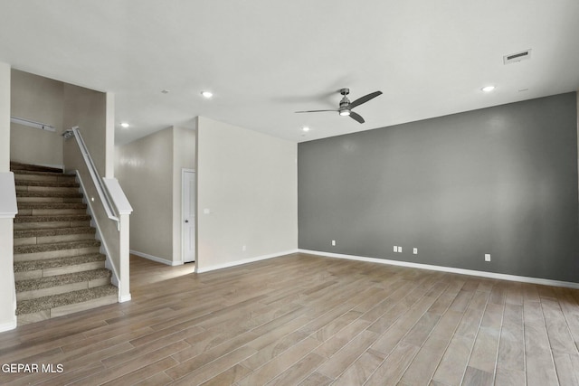 unfurnished living room featuring stairs, wood finished floors, baseboards, recessed lighting, and a ceiling fan