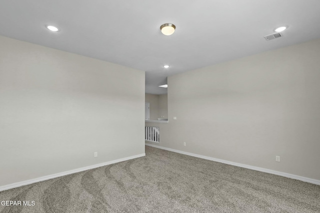 carpeted empty room with baseboards, recessed lighting, and visible vents
