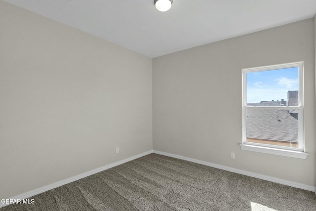 unfurnished room with carpet floors and baseboards