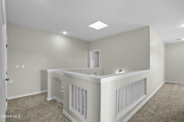 hall featuring baseboards, recessed lighting, and carpet