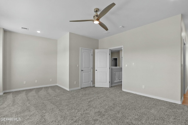 unfurnished bedroom featuring carpet floors, baseboards, and visible vents