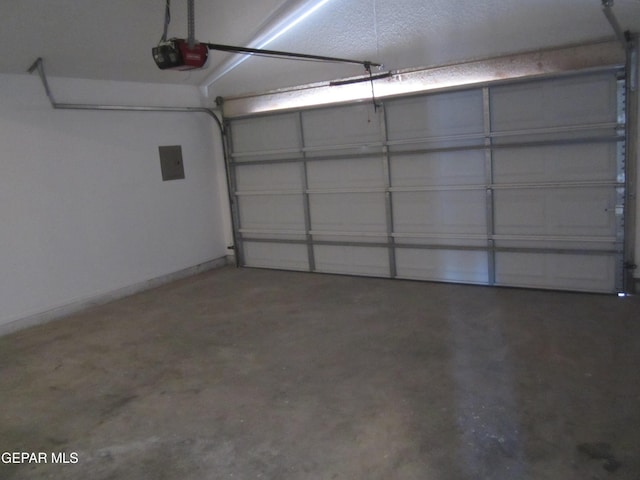 garage with a garage door opener and electric panel