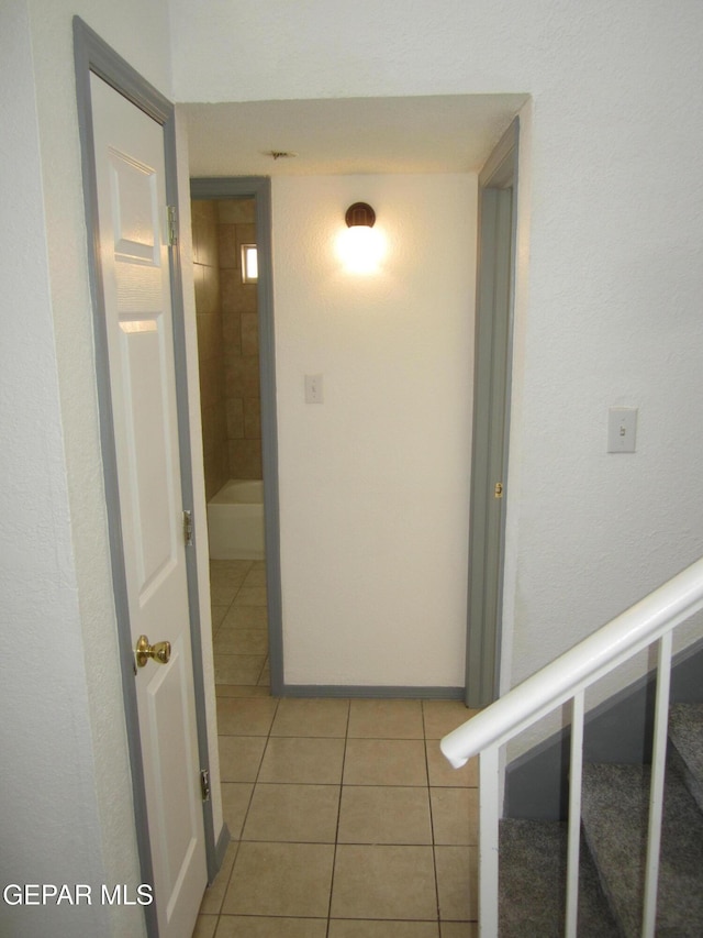 hallway featuring light tile patterned floors