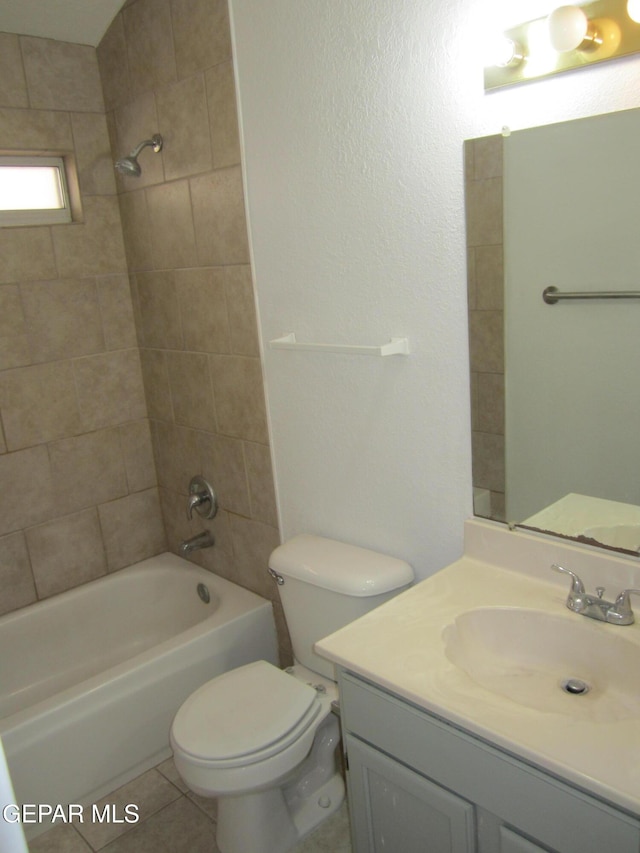 full bathroom featuring toilet, shower / washtub combination, tile patterned flooring, and vanity