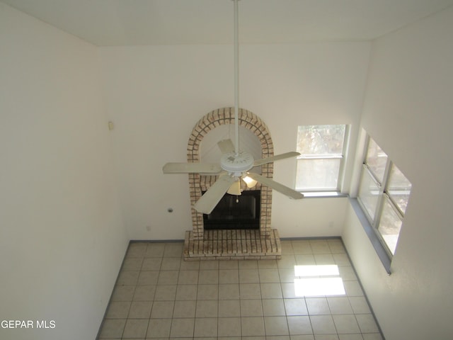 interior space with a ceiling fan and a fireplace
