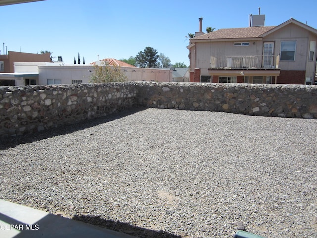 view of yard with a balcony