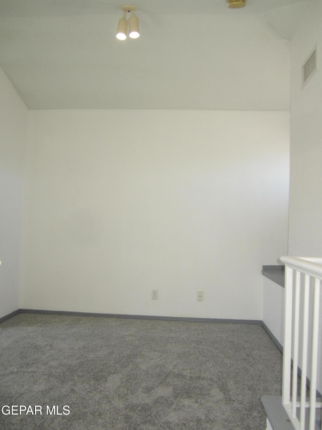 carpeted empty room featuring visible vents and baseboards