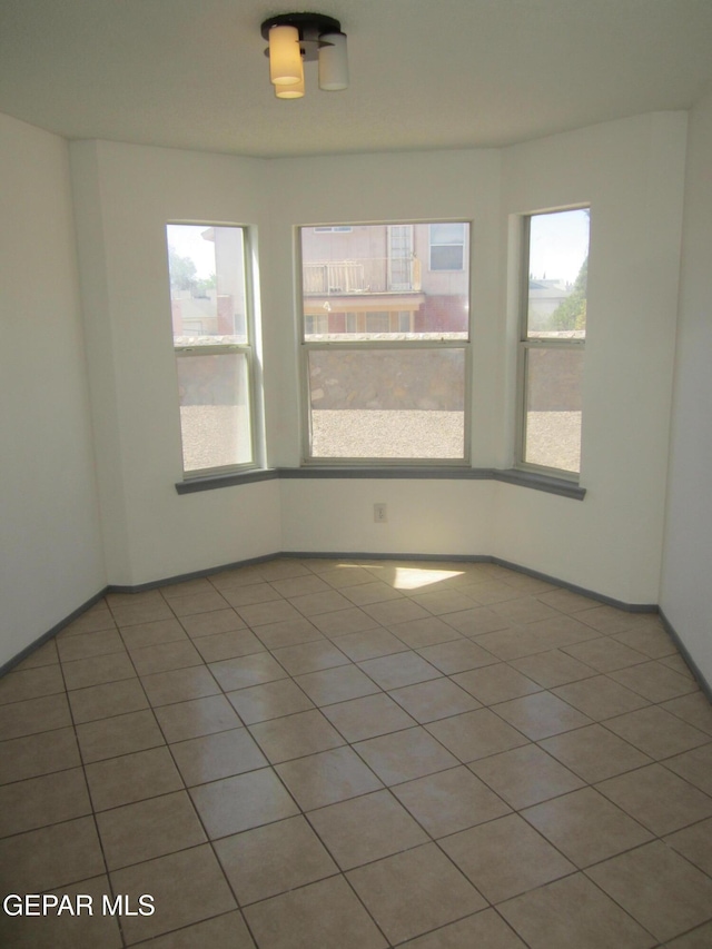 tiled spare room with baseboards