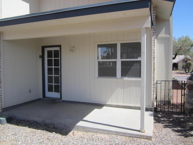 view of exterior entry featuring a patio area