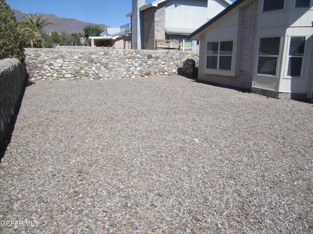 view of yard featuring fence and a mountain view