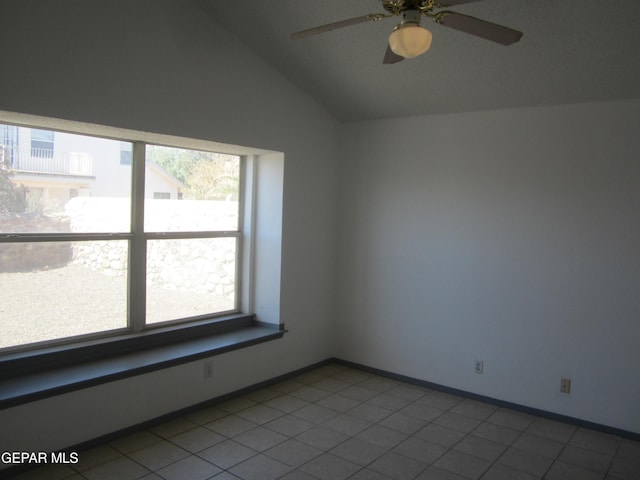 unfurnished room with a ceiling fan, baseboards, and lofted ceiling