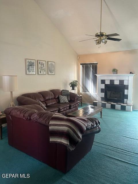 carpeted living room featuring a ceiling fan, high vaulted ceiling, and a tile fireplace