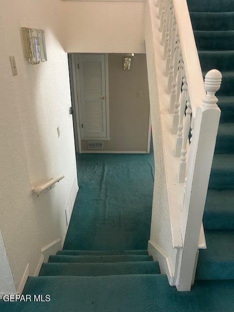 stairs featuring carpet floors, baseboards, and visible vents