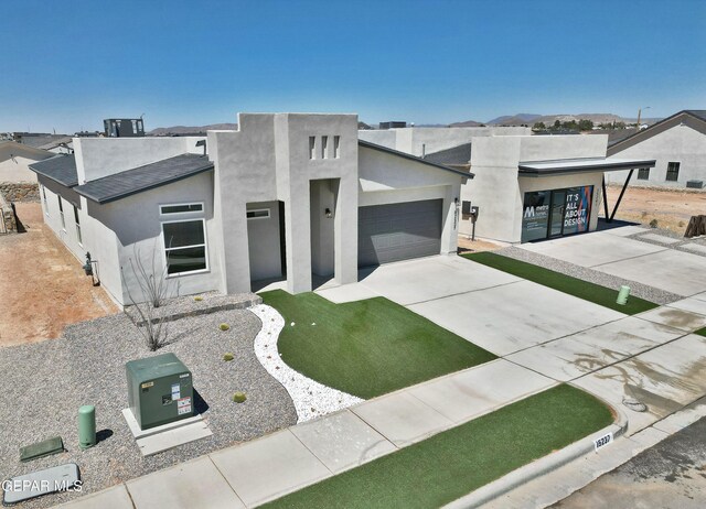 15237 Gauge Ct, El Paso, TX 79938 - modern home featuring a garage, stucco siding, concrete driveway, and a shingled roof
