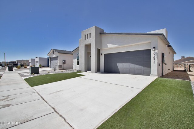 15237 Gauge Ct, El Paso, TX 79938 - view of front facade featuring concrete driveway, an attached garage, and stucco siding
