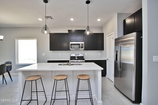 15237 Gauge Ct, El Paso, TX 79938 - kitchen with a breakfast bar area, visible vents, a sink, light countertops, and stainless steel appliances