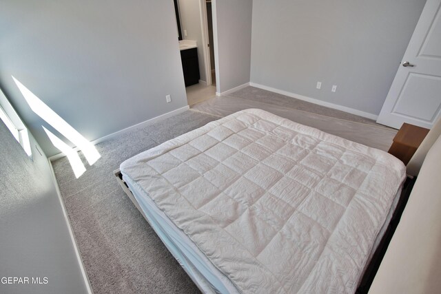 15237 Gauge Ct, El Paso, TX 79938 - bedroom featuring baseboards, connected bathroom, and carpet