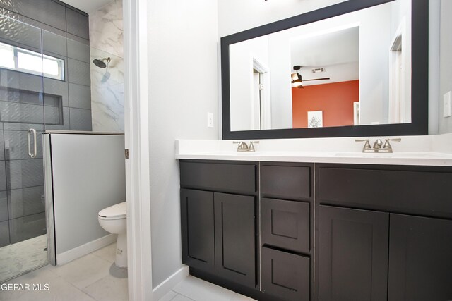 15237 Gauge Ct, El Paso, TX 79938 - bathroom with a sink, double vanity, toilet, baseboards, and a stall shower