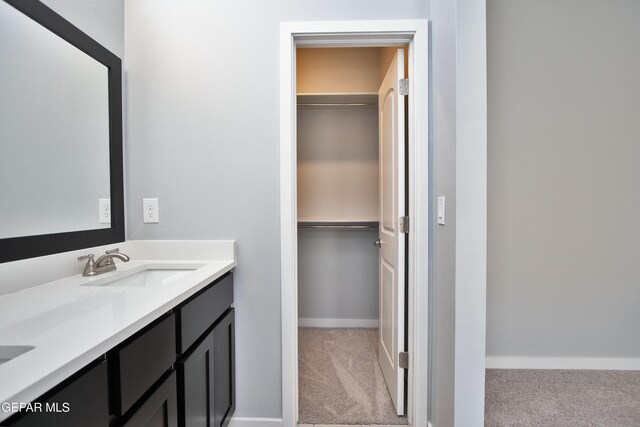15237 Gauge Ct, El Paso, TX 79938 - bathroom with vanity, baseboards, and a spacious closet