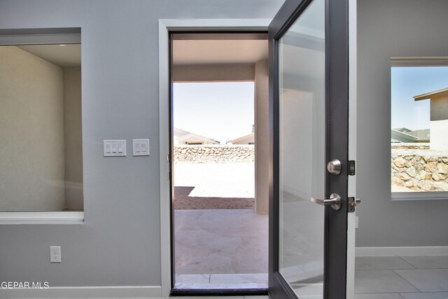 15237 Gauge Ct, El Paso, TX 79938 - doorway with baseboards and tile patterned flooring
