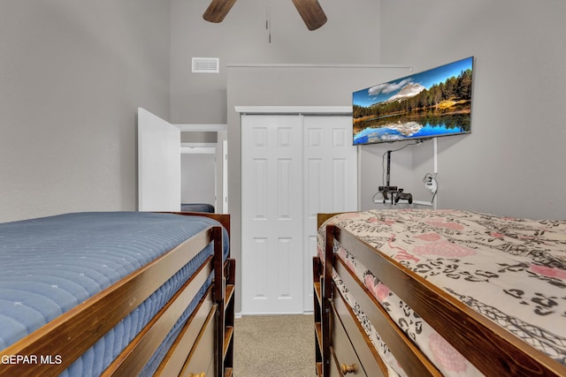 carpeted bedroom featuring visible vents, ceiling fan, and a closet