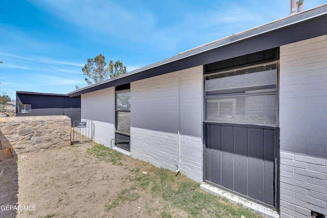 view of property exterior featuring brick siding